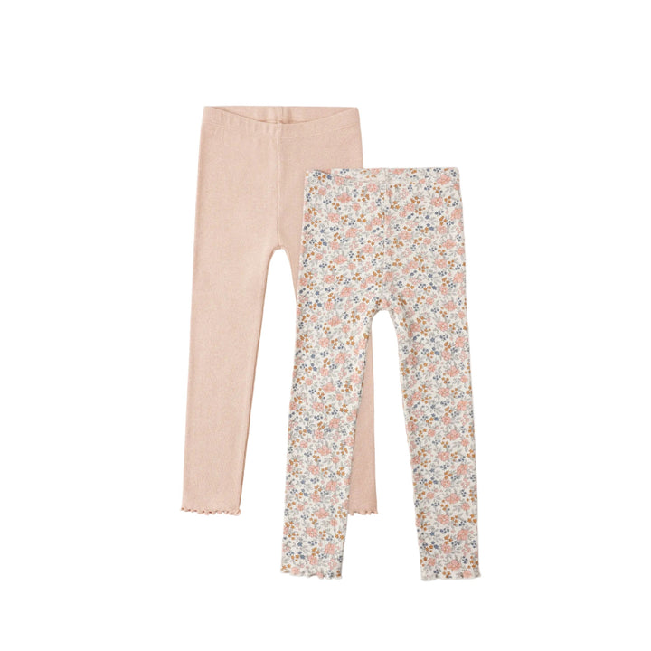 Two pairs of leggings, one plain beige and one with a floral pattern, on a white background.