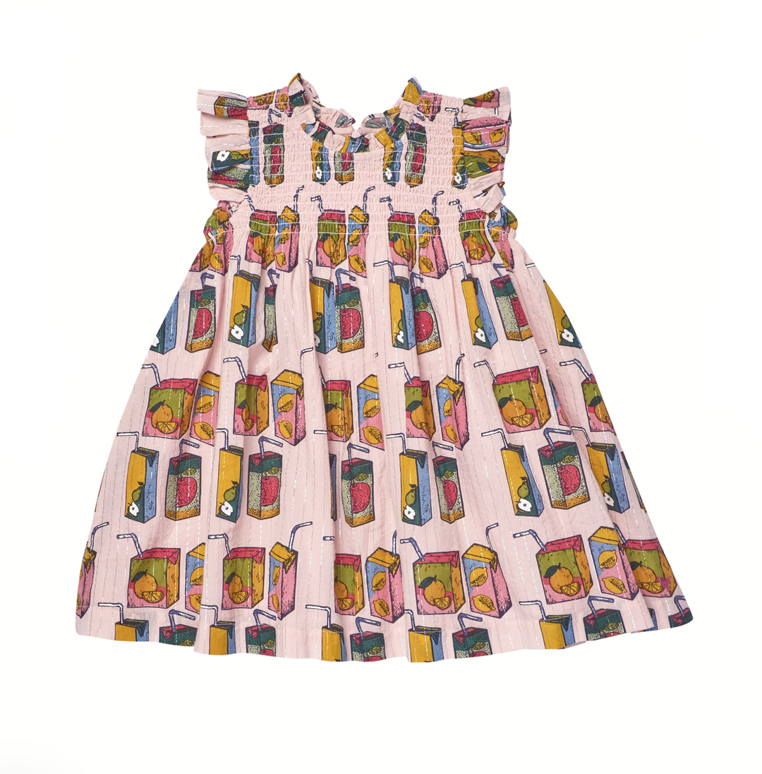 A sleeveless pink dress with a smocked bodice and ruffled shoulder straps, featuring an allover print of colorful juice boxes, shown on a plain white background.