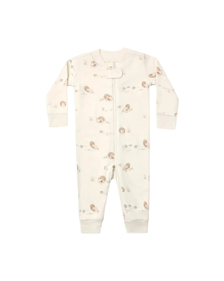 An off-white baby footed sleeper with a full-length front zipper and a delicate all-over print of small brown and beige woodland turkey motifs, shown flat on a light background.