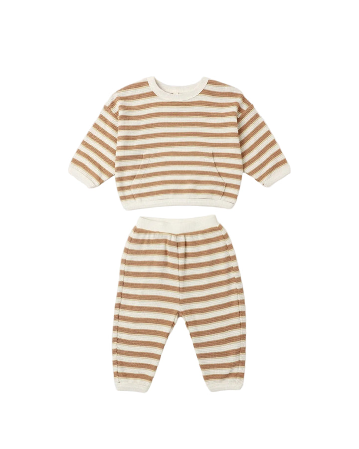 A two-piece baby loungewear set featuring a long-sleeve cropped sweatshirt and matching pants, both with horizontal tan and cream stripes.