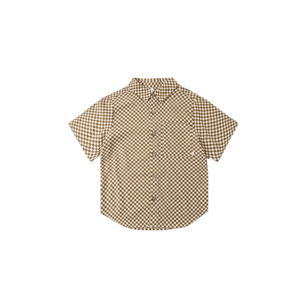 A classic Rylee + Cru collared boys short sleeve button-down shirt with coconut buttons.

Featuring a ‘ocre check’ pattern. Slide into summer in this cool vintage style.