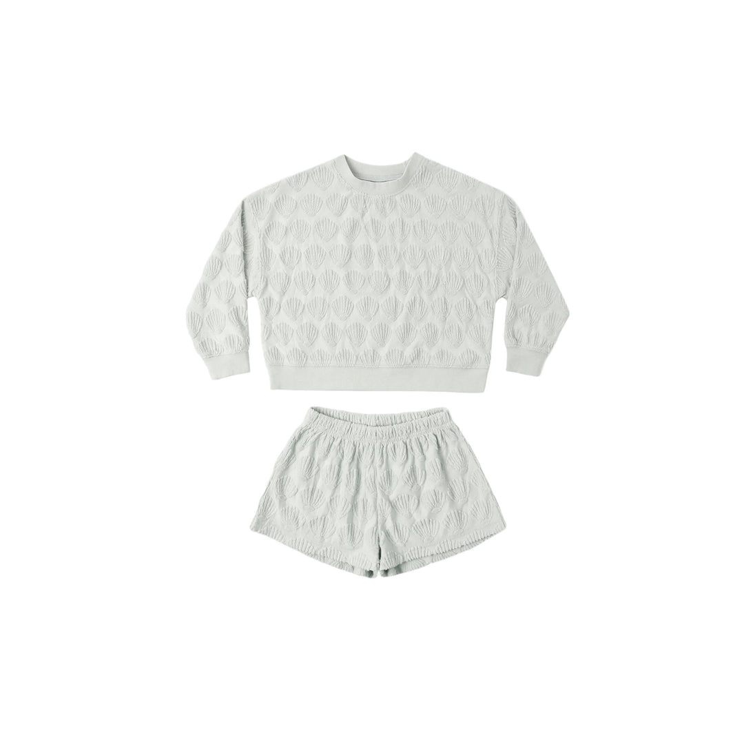 Light blue gray shell patterned sweatshirt and shorts set on a white background