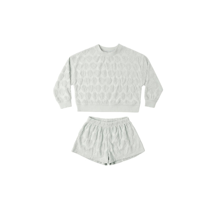Light blue gray shell patterned sweatshirt and shorts set on a white background