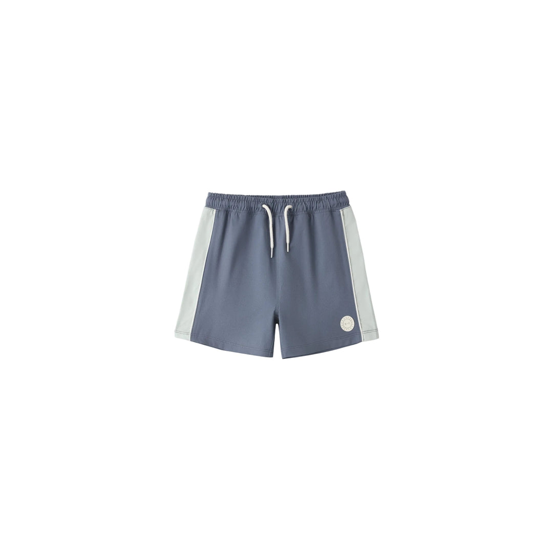 Blue shorts with white side panels on a light gray background