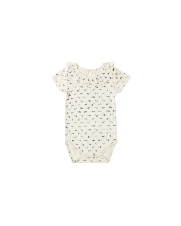 Baby romper with a subtle pattern on a white background