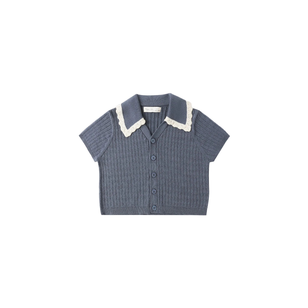 Blue knitted shirt with white collar on a light gray background