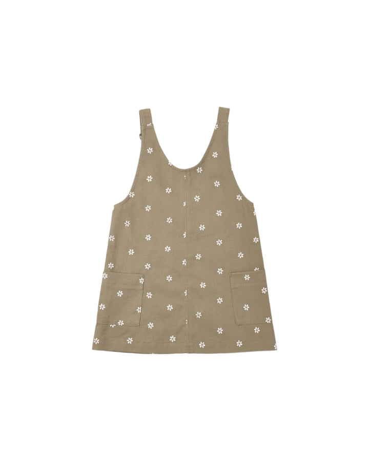 A sleeveless brown vest with a white floral pattern, featuring a button-up front and two front patch pockets, shown flat on a light gray background.