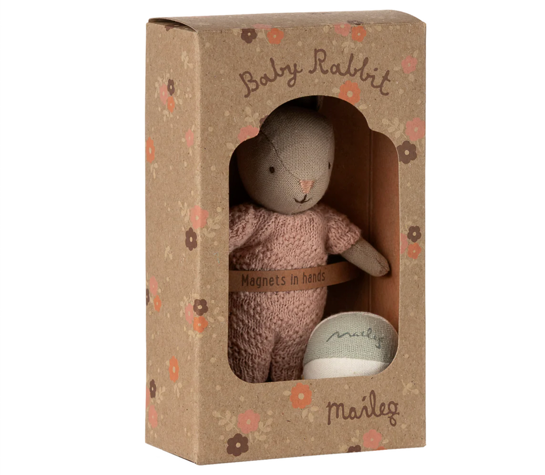 Stuffed rabbit toy in a decorative box with floral patterns
