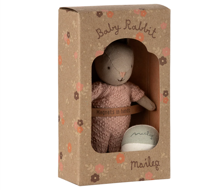 Stuffed rabbit toy in a decorative box with floral patterns