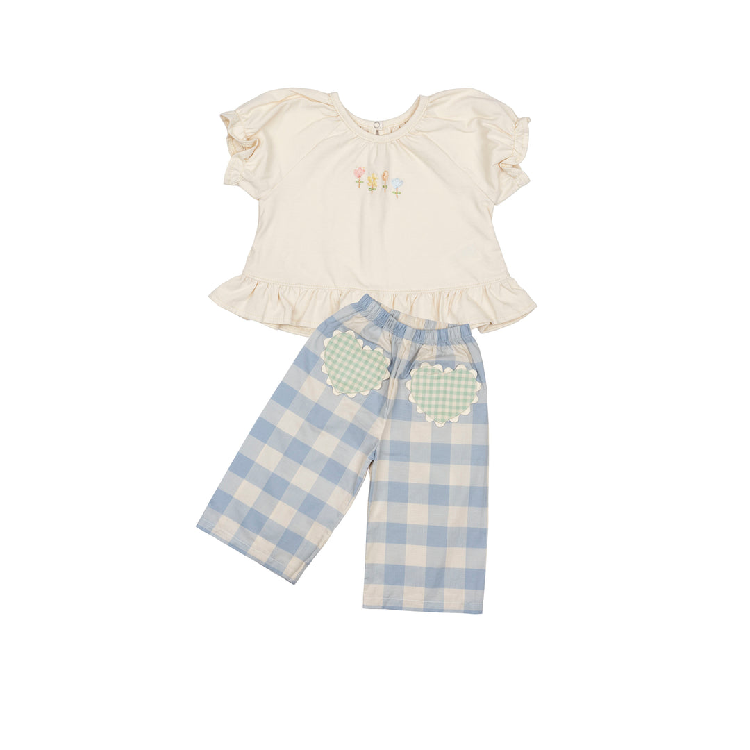 Children's outfit with a white top and blue checkered pants on a white background