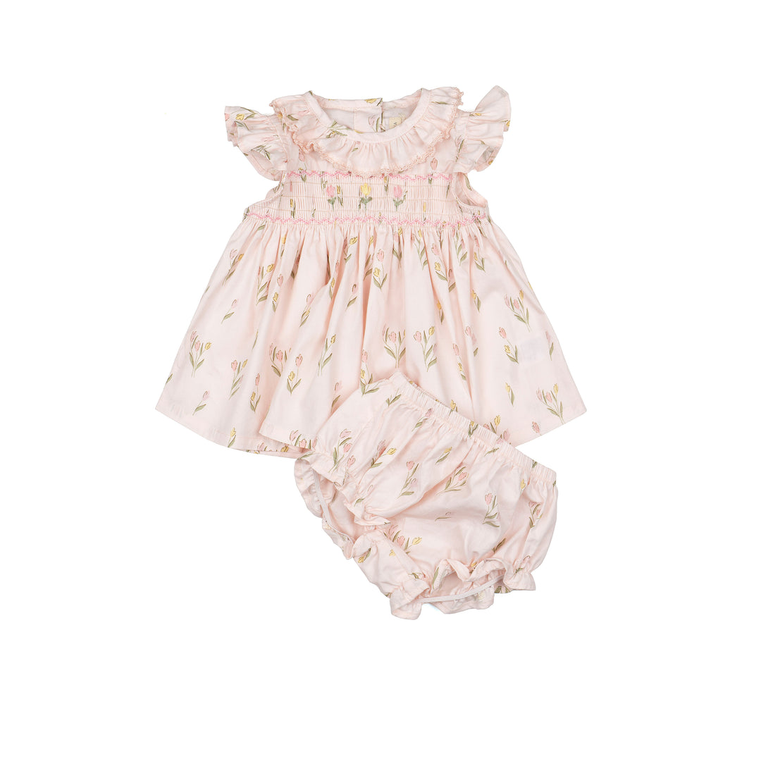 Baby dress and bloomers set with floral pattern on a white background
