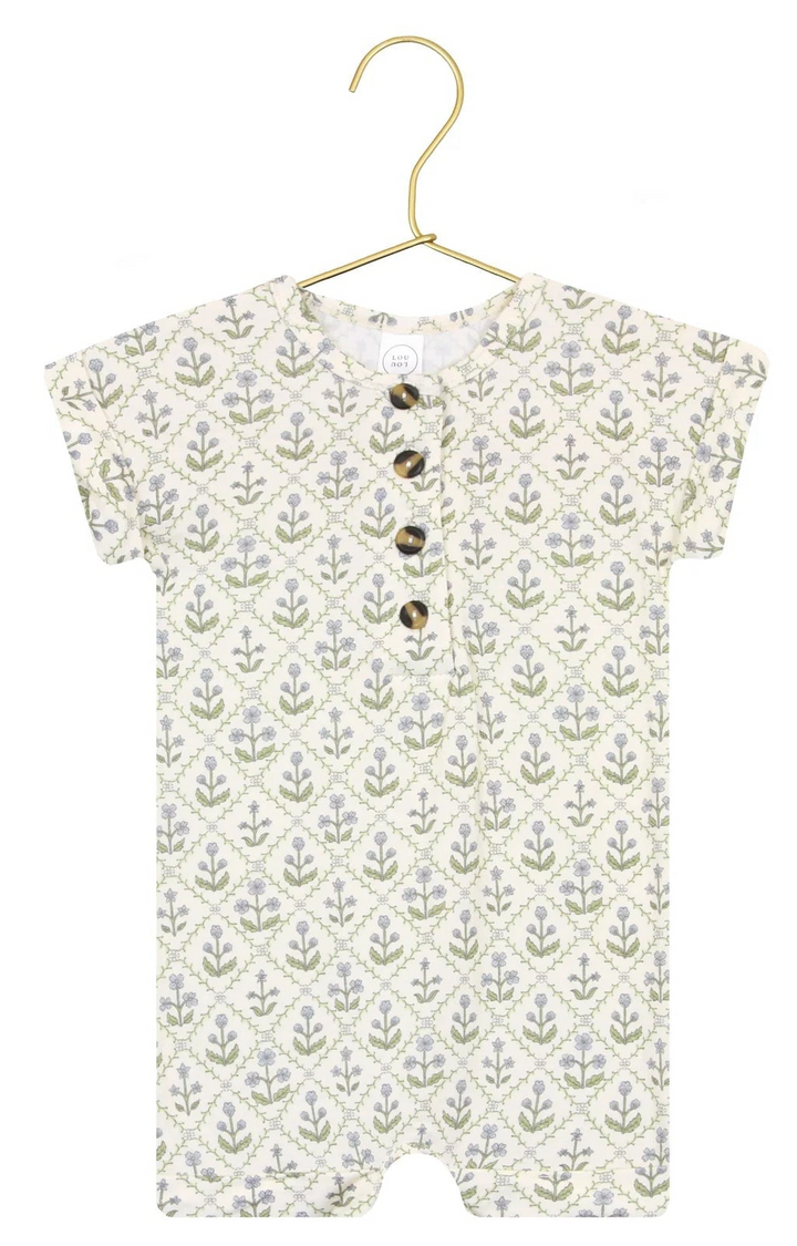 Baby romper with floral pattern on a hanger against a white background