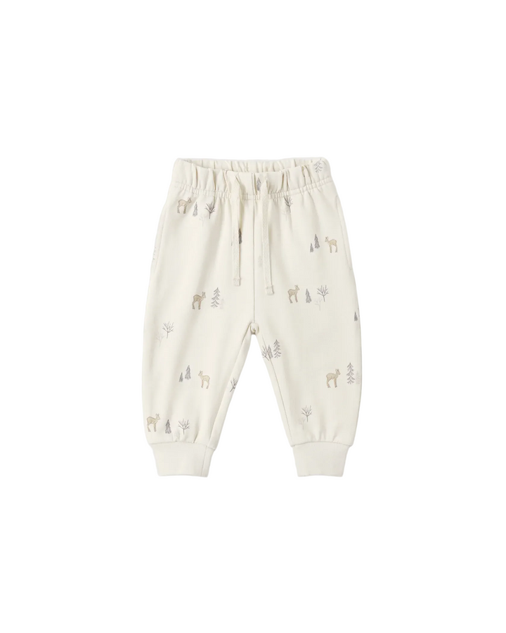 Off-white jogger pants for toddlers, featuring a small woodland animal and tree print in muted gray and beige tones, with an elastic waistband and drawstring.