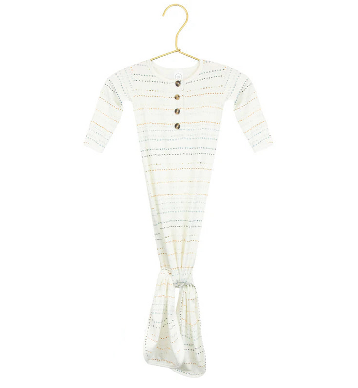 A knotted gown for babies with long sleeves, featuring rainbow dots pattern and button-down front, displayed on a hanger.