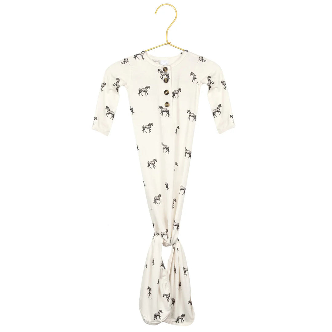 Baby wrap with horse pattern on a hanger against a white background