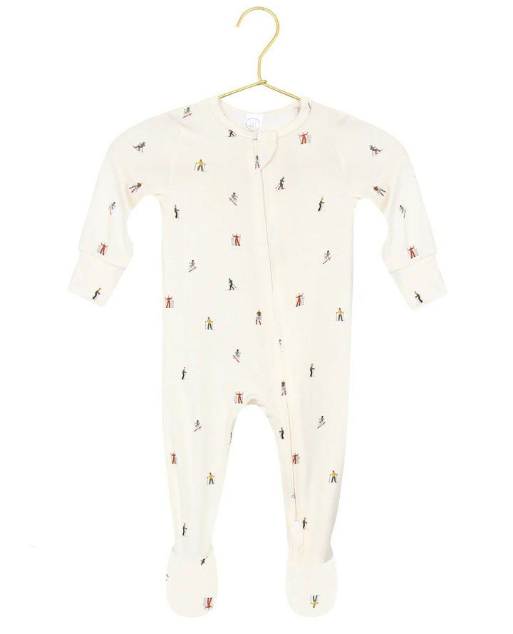 Baby onesie with small print on a hanger against a white background